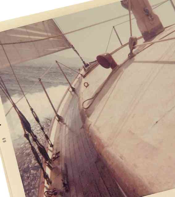 old sailboat heeling over wet deck